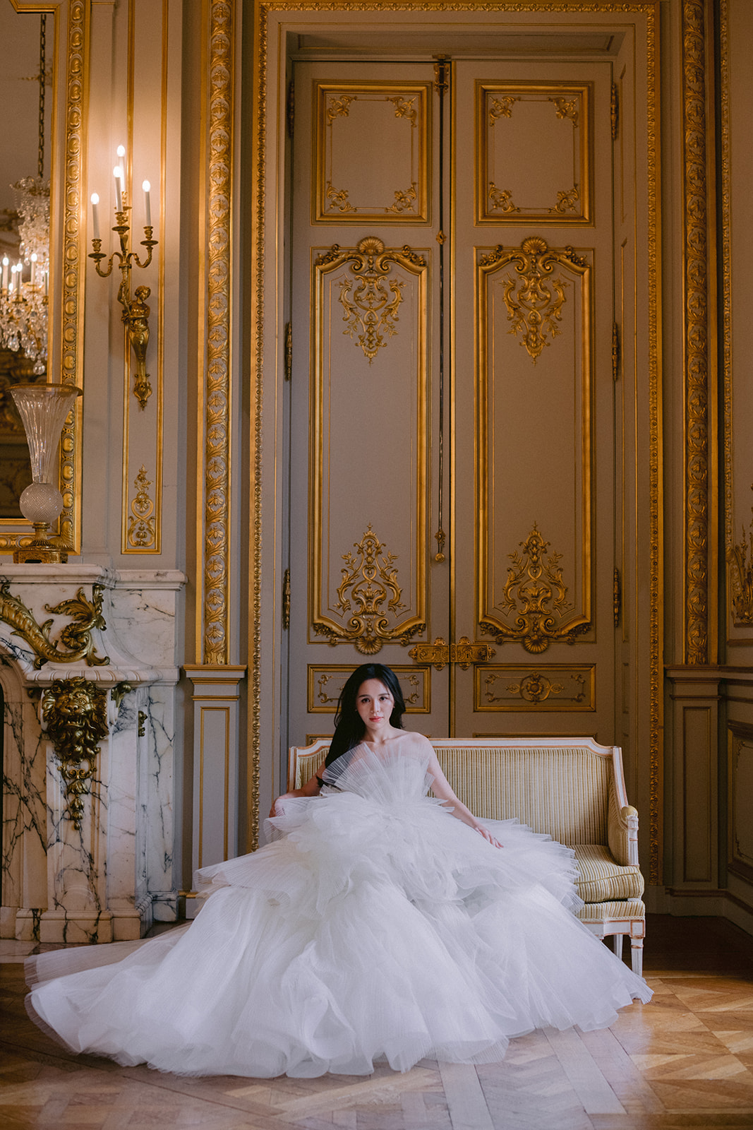  the bride is sitting on an armchair in the reception room